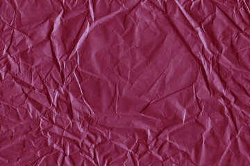 Fototapeta premium Red vintage and old looking crumpled paper background. Retro cardboard texture. Grunge paper for drawing. Ancient book page. Present wrapping.