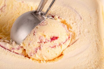 Extreme close up of raspberry ripple ice cream being scooped up