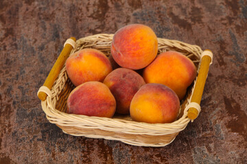 Peach heap in the wooden basket