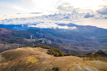 yellow autumn mountains against a background of blue haze and storm clouds