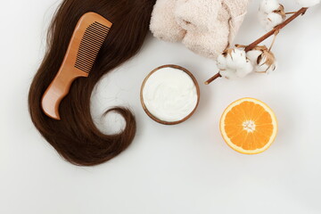 female hair, hair mask yogurt and orange and bamboo comb on white background top view, flat lay. copy space. Self care, hair treatment  concept.