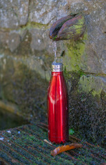 Drinking water concept. water bottle filling up at the fountain