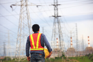 Porrait Senior engineer holding safety helmet looking to power plant