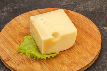 Emmental cheese over wooden board