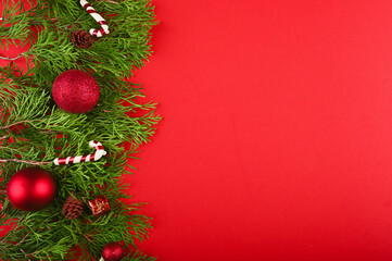 Creative layout made of Christmas tree branches with festive decorations. 