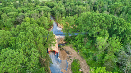 Aerial View of Countryside with a Covered Bridge on a Summer Day