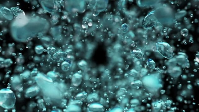 Explosion of water droplets into the camera in slow motion on an isolated black background.