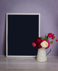 Still life from an empty frame with a black background and a vase of peonies