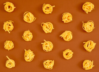 Flat lay composition with noodles raw on color background brown.