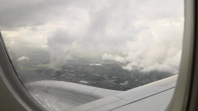 Airplane window view during landing to Amsterdam 