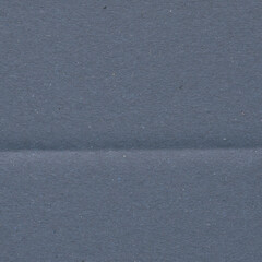 Fototapeta premium A blue vintage rough sheet of carton. Recycled environmentally friendly cardboard paper texture. Simple minimalist papercraft background.