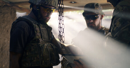 Soldier showing region plan to commander