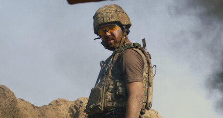 Adult soldier standing in smoke during war