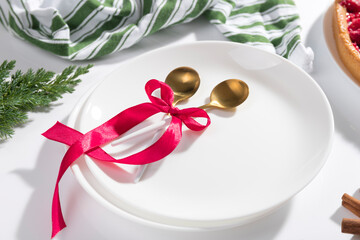 Christmas table setting with red ribbon