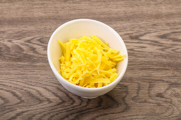 Shredded yellow cheese in the bowl