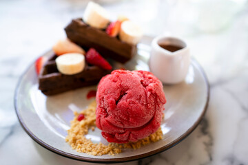 sweet dessert in white dish. Contain honey toast and ice-cream and strawberry 