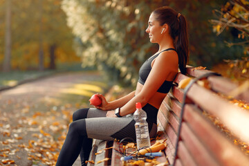 Beautiful girl training. Sports girl in a sportswear. Brunette in a black top