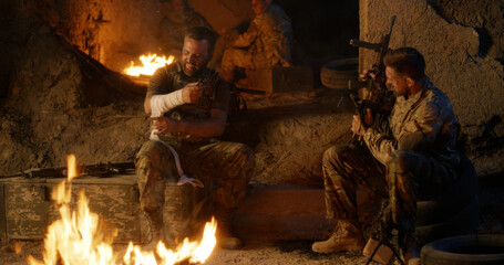 Angry military men resting near fire