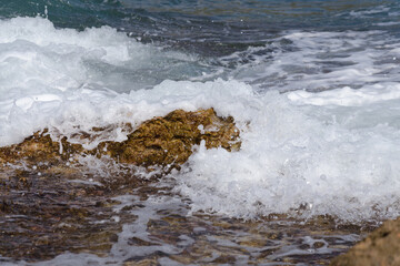 Sea waves break against the rocky coastline in Sierra de Irta Natural Park, Castellon, Spain
