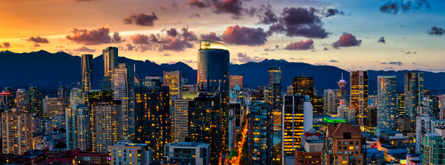 Obraz premium Aerial Panorama of the beautiful modern downtown city during the night after sunset. Vancouver, British Columbia, Canada. Colorful Clouds Artistic Render