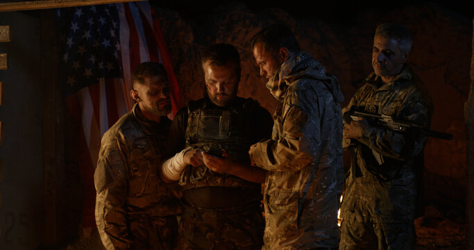 American soldiers browsing smartphone at night