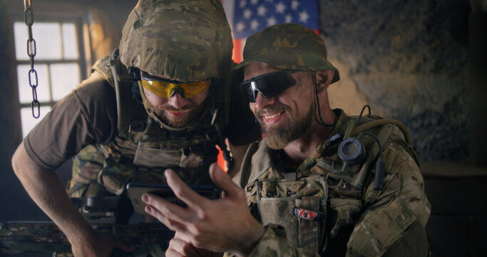 Male soldiers using smartphone together