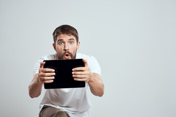 emotional man with tablet in hand touch screen new technologies light background cropped view Copy Space