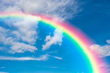 Blue sky with clouds and rainbow