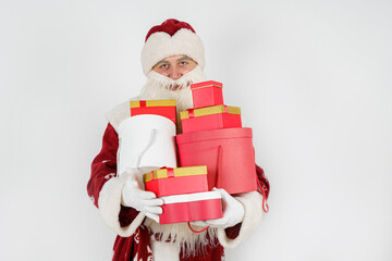 Santa Claus holds gifts in his hands. Isolated on white