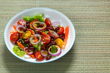 Light plate with pan-Asian salad with sesame seeds and tamarind on a bamboo tablecloth
