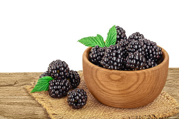 blackberry in bowl on wooden table isolated on a white background. Clipping path and full depth of field
