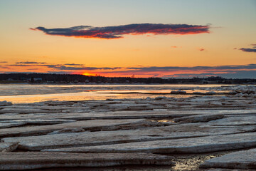 Frozen sea with floating ice sheets during sunset in Charlottetown Prince Edward Island, Canada
