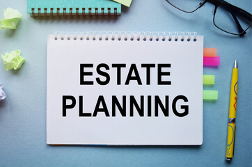 The inscription ESTATE PLANNING. Handwritten text in a notebook on the background of financial...