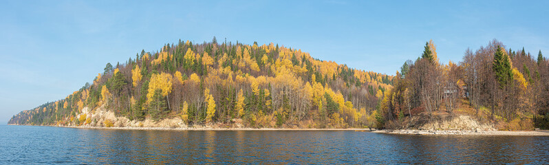 Panoramic autumn landscape, hilly and rocky shore of the river yellow, Golden leaves.