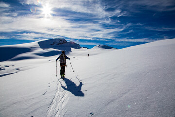 person ski touring in the swiss alps