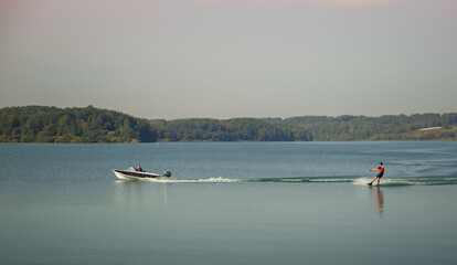 Fototapeta na wymiar sportsman wakeboarder rides behind a boat