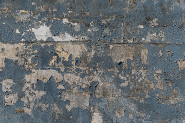 Peeling black paint on old fabric.