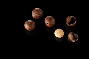 Macadamia nut on a black background with reflection