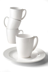 Porcelain cups and plates on white background, photo taken in studio