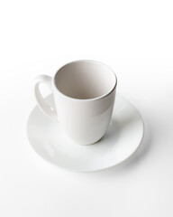 Porcelain cups and plates on white background, photo taken in studio