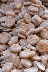 Pile of dried figs, coated in wheat flour, on a market stall