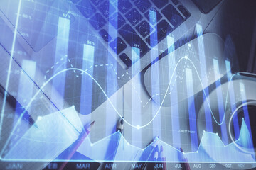 Double exposure of financial chart drawing over table background with computer. Concept of research and analysis. Top view.