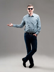 A man in a jacket gesticulates with his hands on an isolated background
