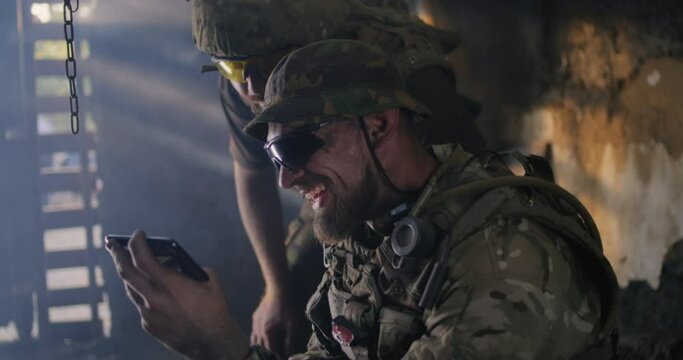 Male soldiers using smartphone together