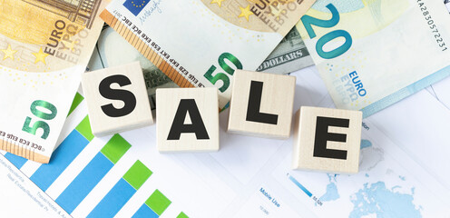 SALE word on wooden cubes, cubes stand in the background - business diagram. Business and finance concept
