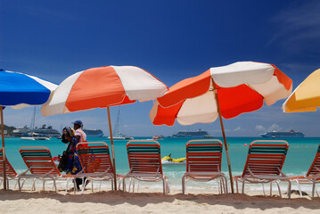 Colored beach umbrellas at Great Bay Philipsburg with peddler