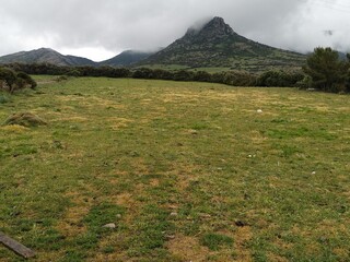 Fototapeta premium Beautiful green landscape and mountain on a foggy day