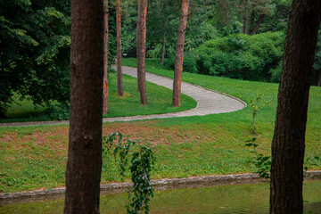 park outdoor scenery landscape paved road for walking and pond reservoir nature environment space without people here in spring day