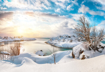 Breathtaking winter scenery with lots of snow  in small fishing village and snowy  mountain peaks...