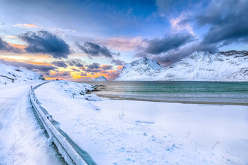 Fabulous winter view of Vik beach during sunset with lots of snow  and snowy  mountain peaks near Leknes.